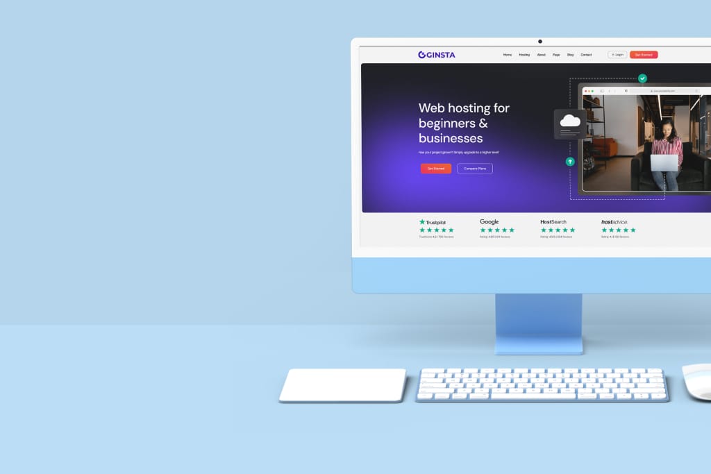 Een desktopcomputer toont een webhostingwebsite met een paars thema, op een lichtblauw bureau met een toetsenbord en trackpad.